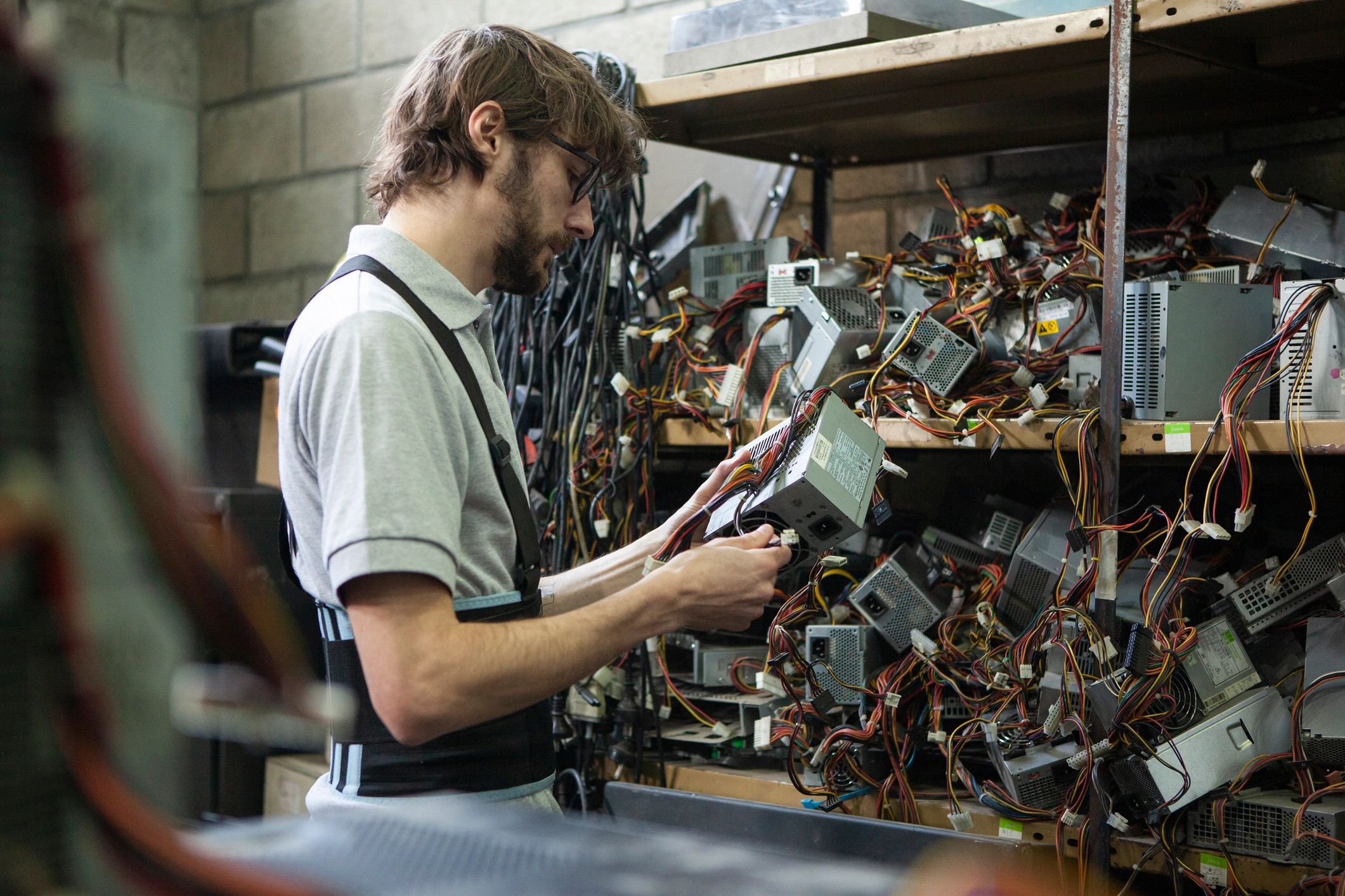 Technician working with computer and cabling equipment
